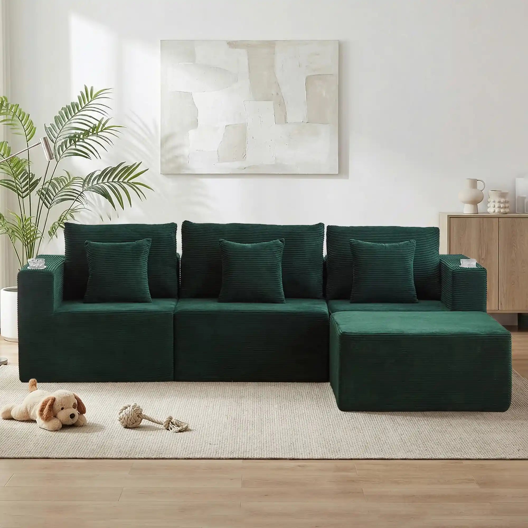 Green modular sofa bed with three back pillows and long chaise extension